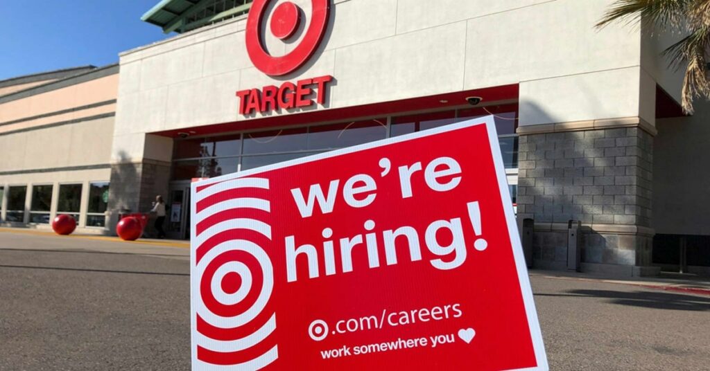 Target's 'We're Hiring' sign outside a store, promoting job opportunities on a sunny day.
